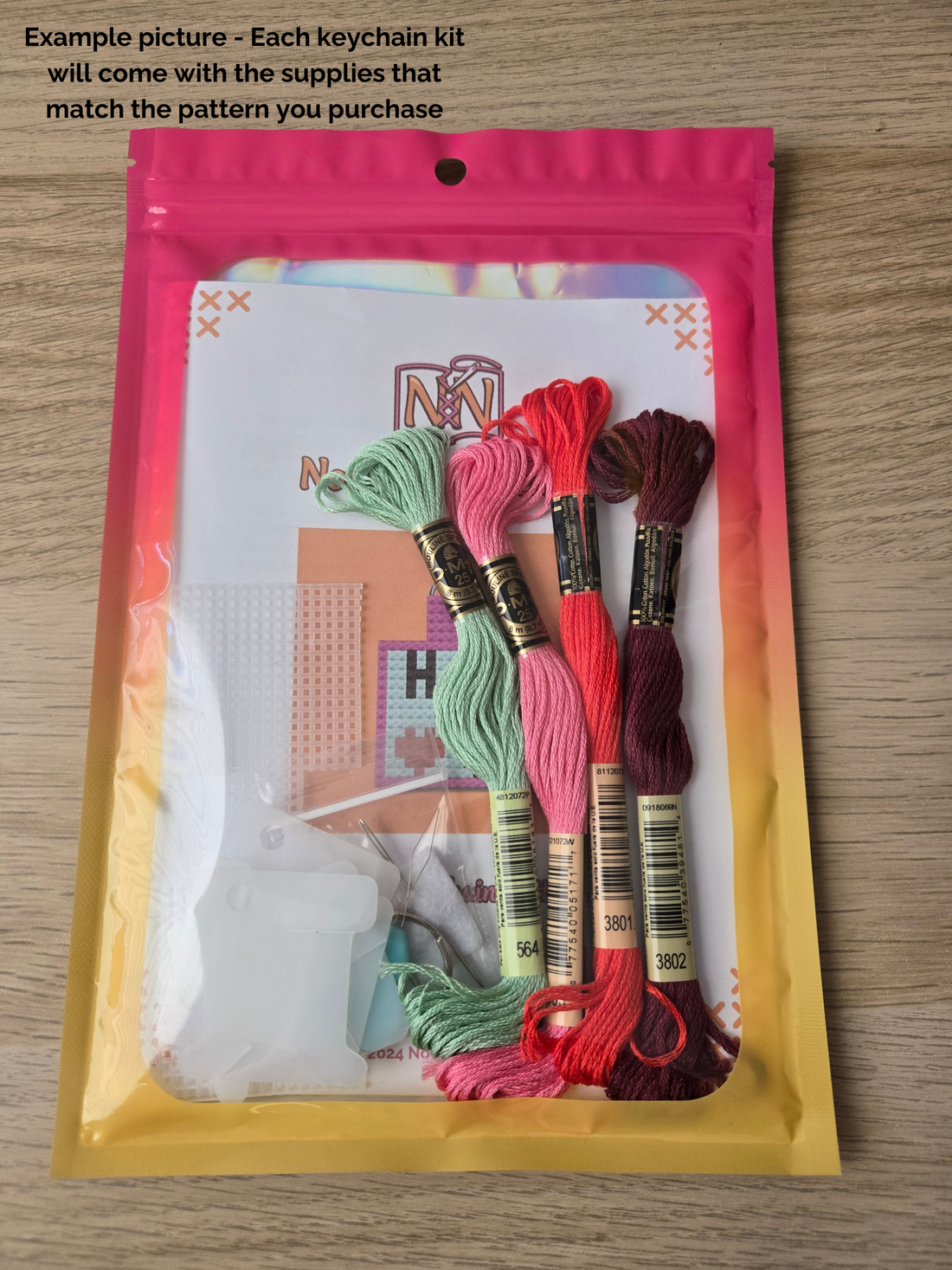 Small, pre-packaged cross stitch keychain kit.