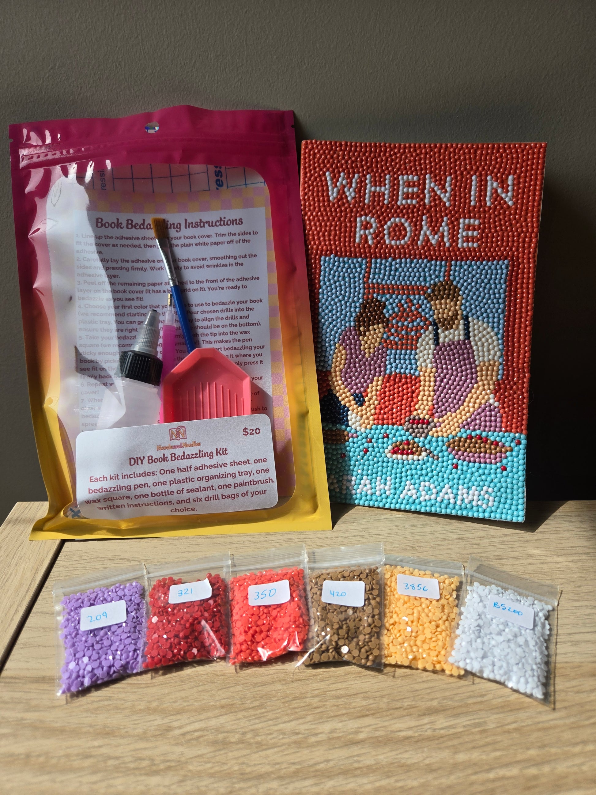 DIY Book bedazzling Kit with a finished bedazzled book and six of the colored drills you can choose from.